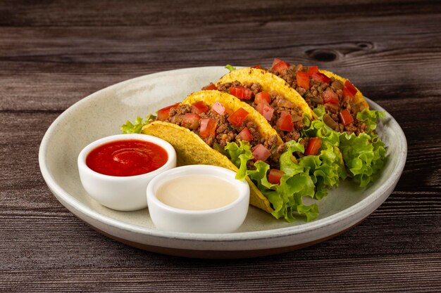 Mexican tacos with lettuce beef and tomatoes