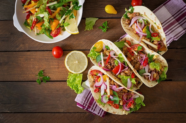 Mexican tacos with meat, beans and salsa