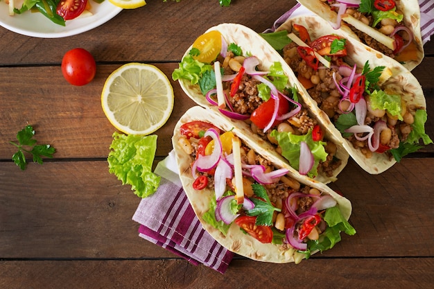 Mexican tacos with meat, beans and salsa