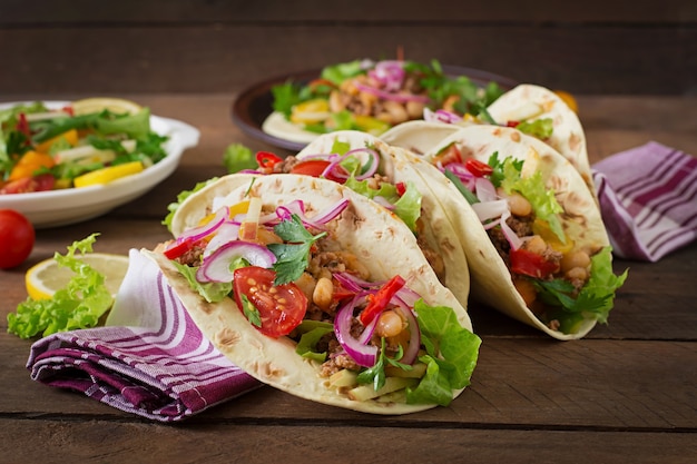 Mexican tacos with meat, beans and salsa