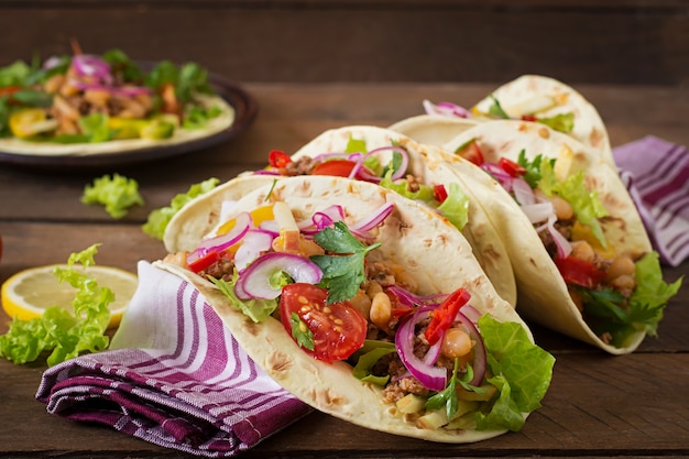 Mexican tacos with meat, beans and salsa