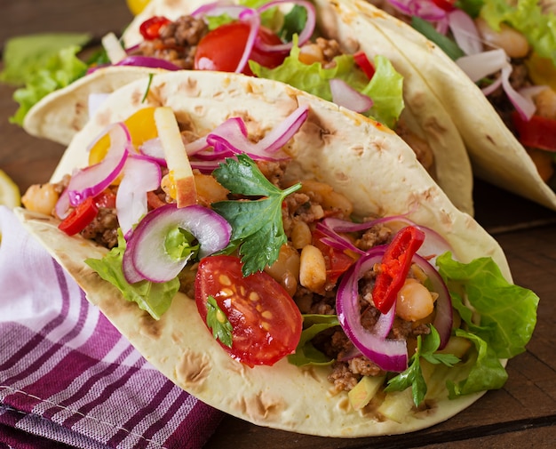 Mexican tacos with meat, beans and salsa