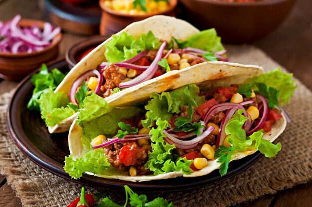 Mexican tacos with meat vegetables and red onion