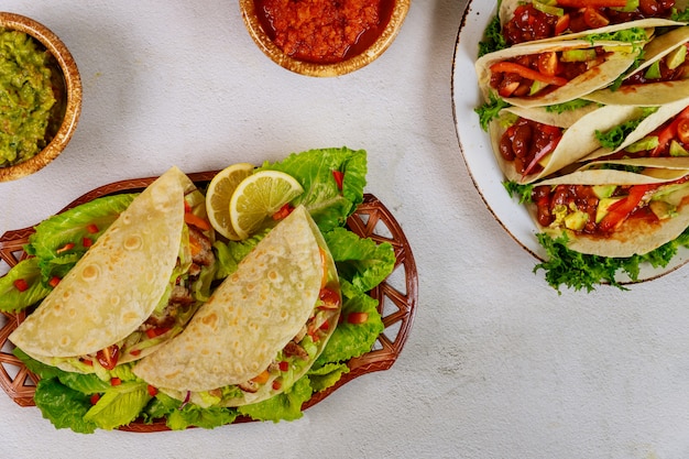 Mexican tasty food soft tortilla stuffed with green salad and meat