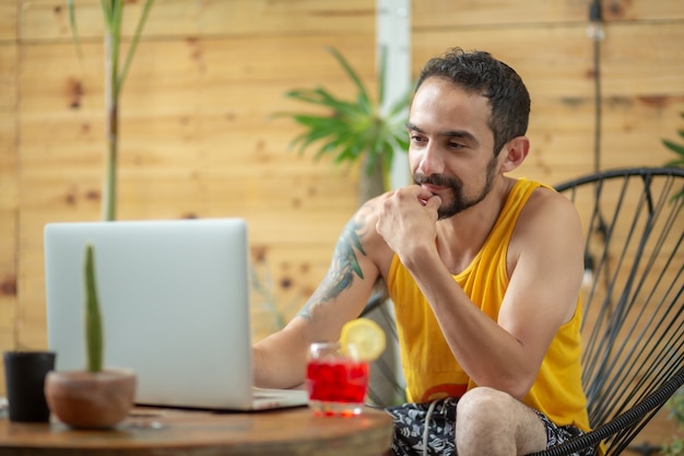 Mexican young man working on summer vacation copy space