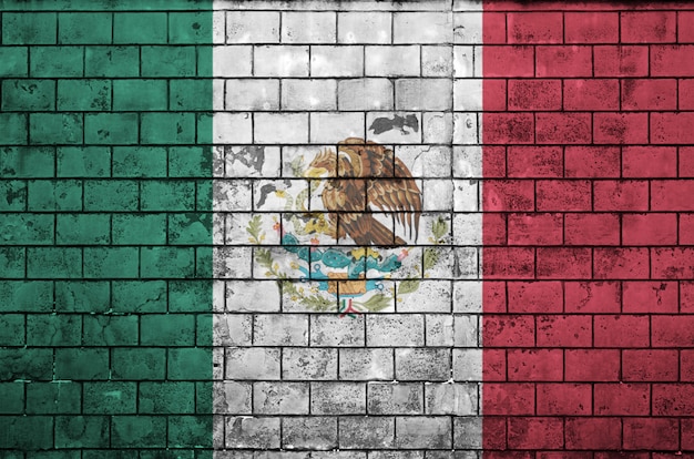 Mexico flag is painted onto an old brick wall