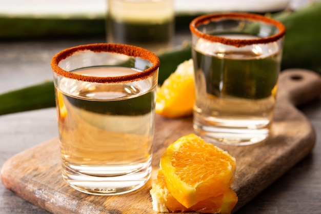 Mezcal Mexican drink with orange slices and worm salt