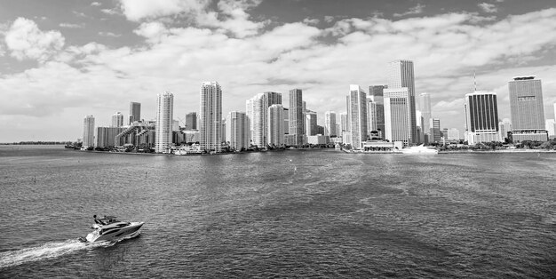 Miami skyline skyscrapers yacht or boat sailing next to Miami downtown Aerial view south beach