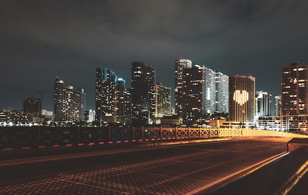 Miami sunset panorama with colorful illuminated business and residential buildings and bridge on Biscayne Bay Miami night downtown city Florida