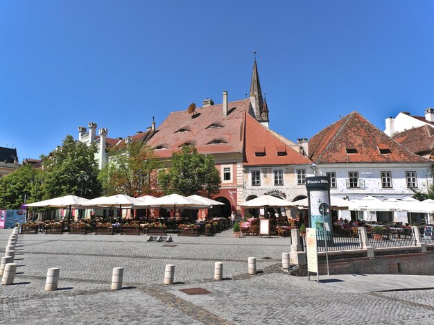 Mica square in sibiu romania the red tile roofs from the city with awnings looking like eyes these eyes are one of the symbols of the city