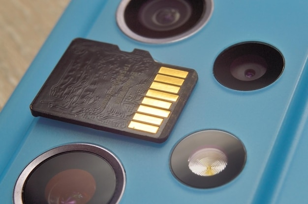 Micro sd card lies on the block of smartphone cameras closeup