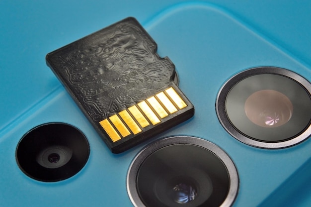 Micro sd card lies on the block of smartphone cameras closeup