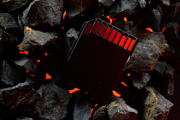 Photo the micro sd card lies on hot coals closeup