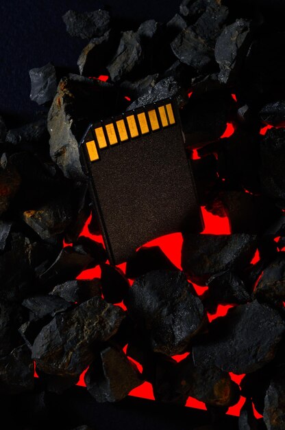 Photo the micro sd card lies on hot coals closeup