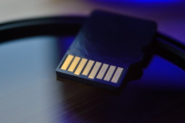 Micro sd card for use in photo and video technology. micro sd lies on the lens filter. close-up.