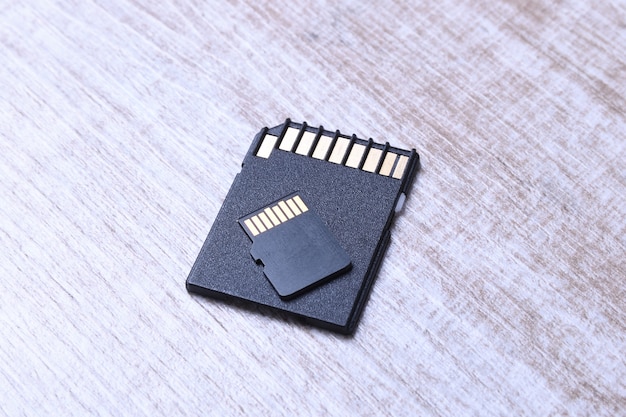 Micro SD memory card adapter on the wooden table. close up