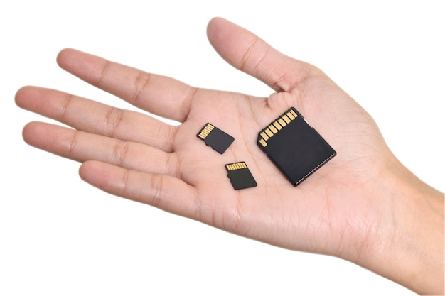 Photo micro sd and memory cards in hand on white