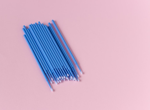 Microbrushes on a pink background. Materials for cleansing makeup, artificial eyelashes.