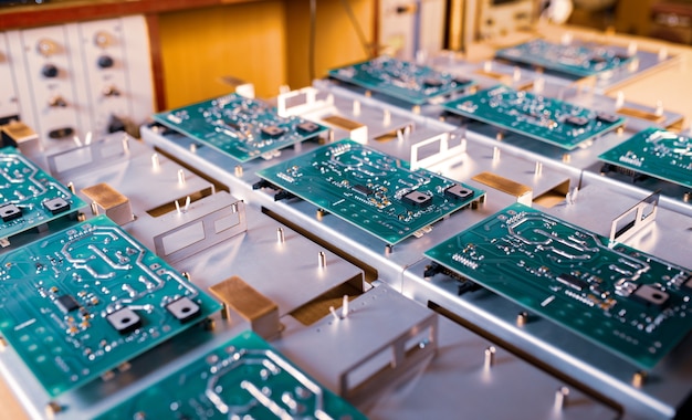 Photo microcircuits and components lie on metal plates during the production of super modern military computers and spy equipment. concept of a secret military factory