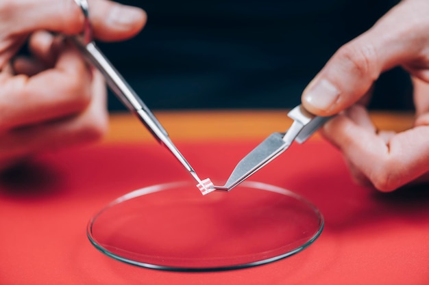 Photo microdosing lsd preparing a micro dose cutting a tab of lsd into pieces