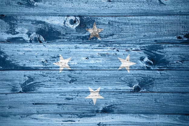 Micronesia flag on wooden planks background wood flag