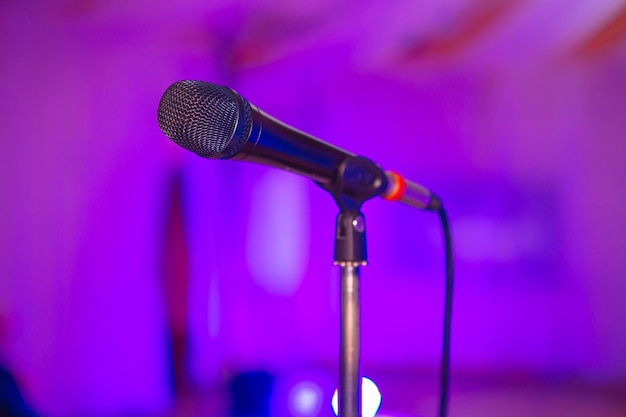 Microphone on the blurred background of the audio mixer of the musician