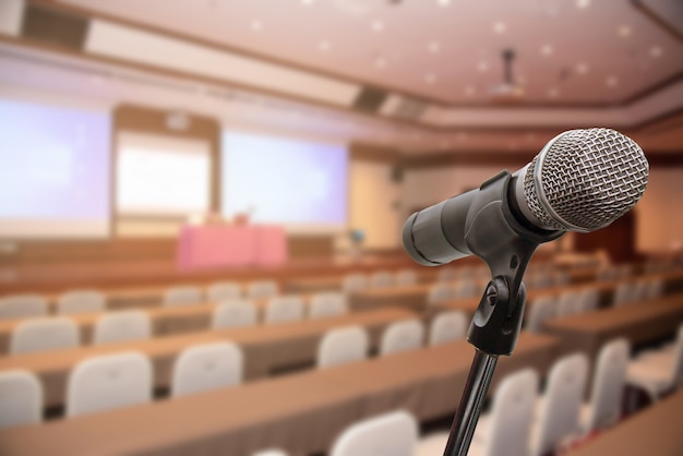 Microphone over the blurred forum Meeting Conference Training Learning Coaching Concept, Blurred background.