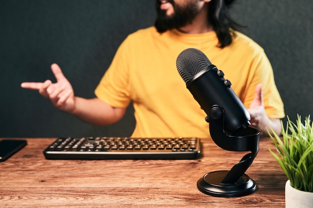 Photo microphone in broadcasting homemade studio with a young man chatting live