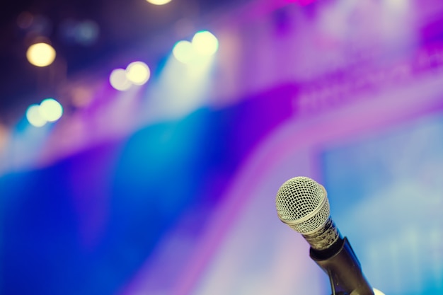 Microphone in the conference hall or seminar room background.