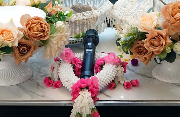 Microphone and flowers on table in a wedding reception for thai wedding traditions