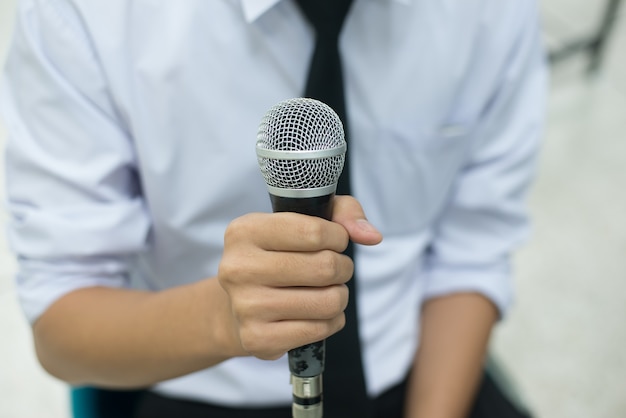 Photo microphone in hand of a man