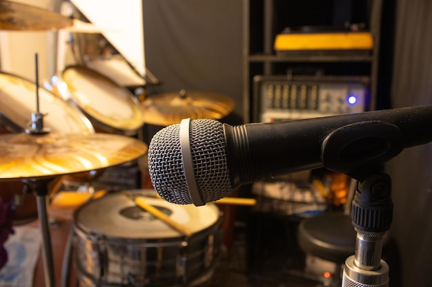 A microphone is in front of a drum set.