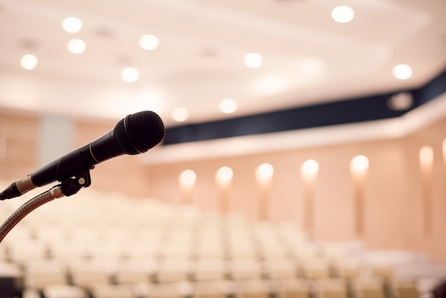 Photo microphone is located on the podium in a conference room. large meeting or seminar room