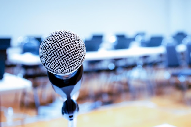 Microphone and Notebook on abstract blurred of speech in seminar room