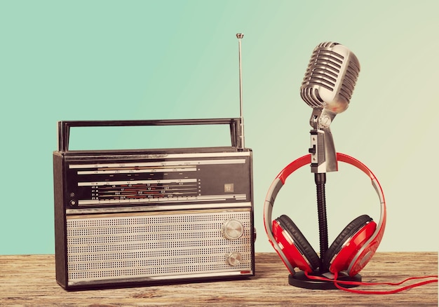 Microphone, radio and headphones on wooden table