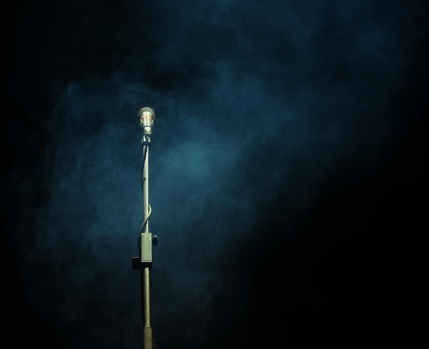 Microphone in a smoke on a dark background