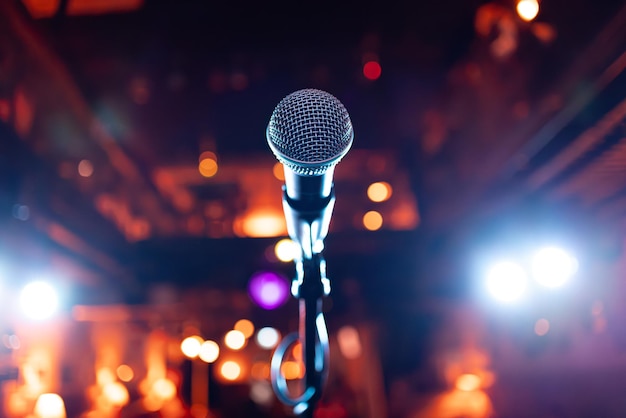 Photo microphone on stage against a background of auditorium