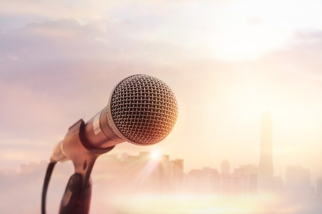 Microphone on stage in the city on sunset background