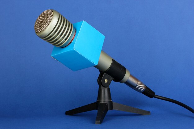 Microphone on stand on blue background