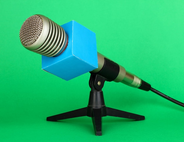 Microphone on stand on green background