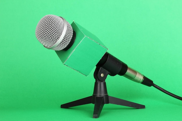 Microphone on stand on green background