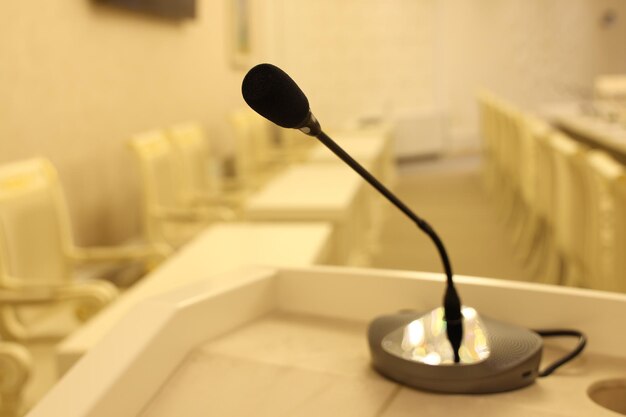 Microphone on the table in the conference room blurred background