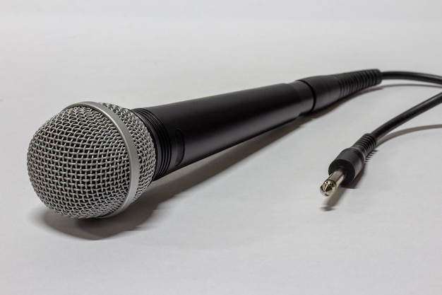 Microphone with cable on white surface selective focus