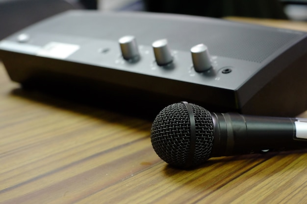 Microphone with mini power amplifier on wooden table