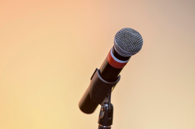 Microphone with pedestal in an environment with a background of lights and colors