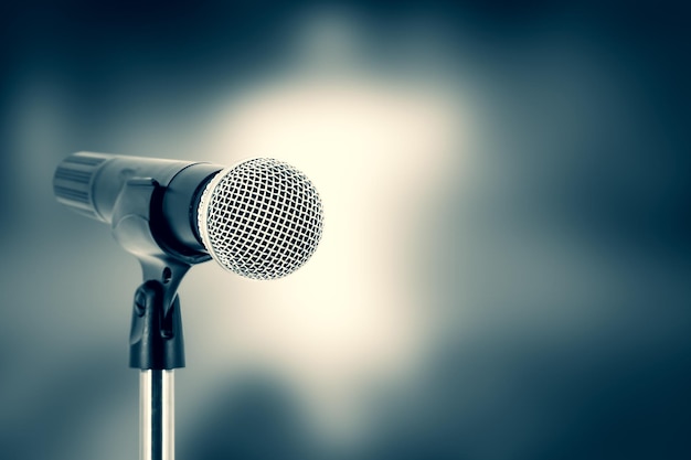 Microphone with stage light background for performance concept of speech comment and public speaking