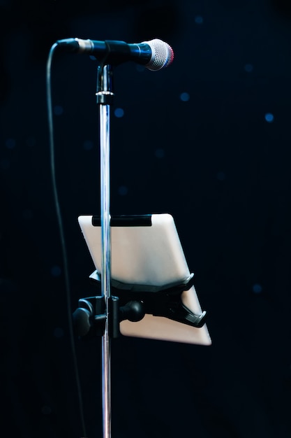 Microphone with a stand and a tablet that attaches to the stand