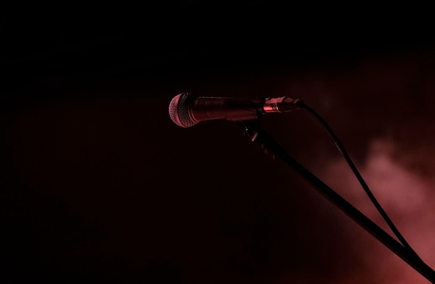 Microphones prepared for the concert in the dark stage shows dark blue background an empty dark scene