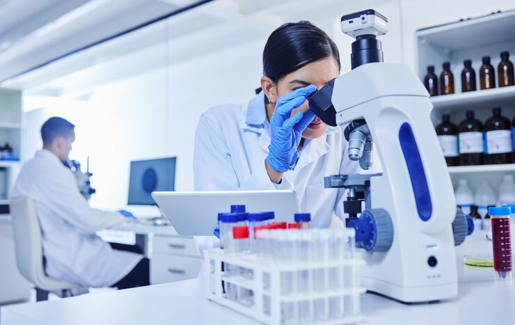 Photo microscope scientist and research in lab with study for pathology vaccine test and medical innovation woman tablet and investigation with biotechnology for stem cell science and development