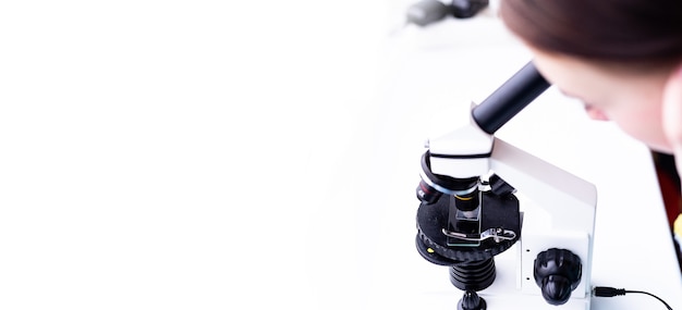 Photo the microscope stands on a white table in a research laboratory conducting analysis and research